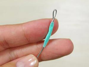 1st end of wire bent and secured